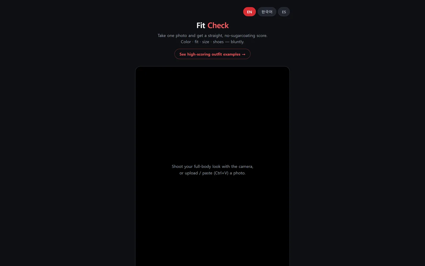 FitCheck start screen. Language toggles for EN, Korean and ES sit at the top; under the title and tagline, an empty capture area prompts the visitor to shoot a full-body photo with the camera or upload one.